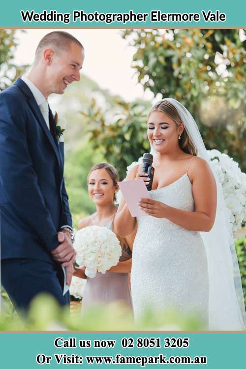 The Bride reading a note as the Groom happily listens Elermore Vale