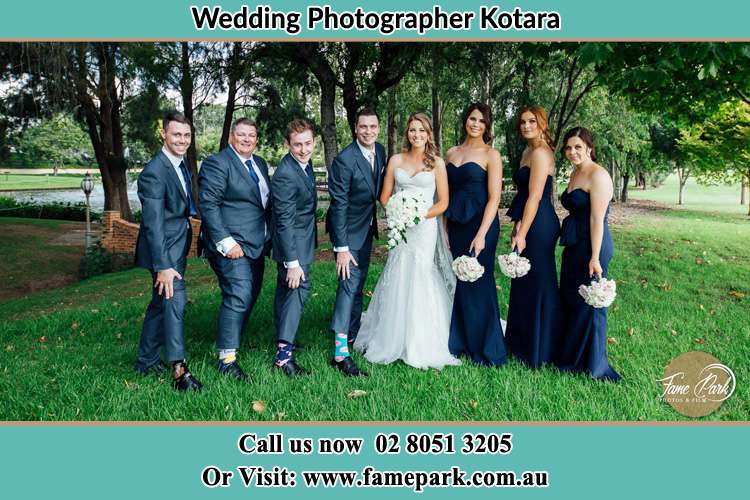 The Bride and the Groom with their entourage pose for the camera Kotara